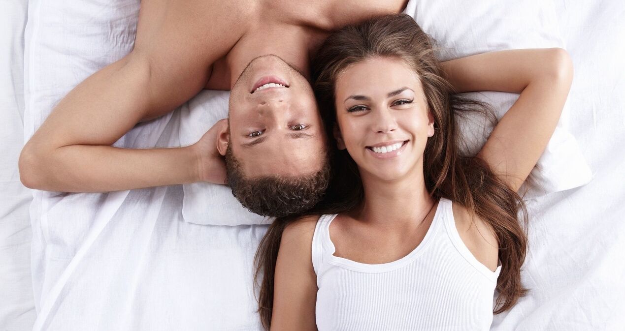 A woman in bed with an enhanced man